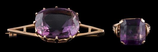 An amethyst brooch: the cushion cut amethyst in a claw setting, on a tapered bar brooch,