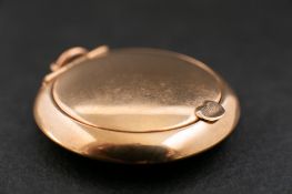 A 9ct gold circular compact,: with a mirror to inside of lid, hallmarks for Birmingham, diameter ca.