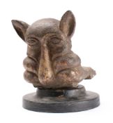 A 19th Century cast iron gargoyle water hopper bracket: with grotesque face and pointed ears,