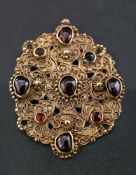 A 19th century, Indo-Persian, gold garnet pendant,: with canetille work of stylised floral design,
