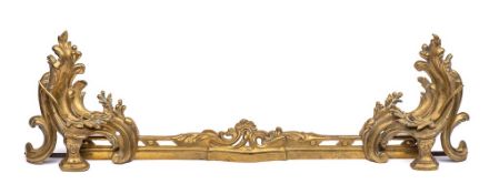 A 19th century gilt metal adjustable fire kerb in Louis XV style: with sliding adjustable foliate