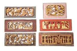 A collection of six Chinese carved wood panels: with pierced floral decoration heightened in gilt,