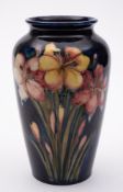 A Moorcroft pottery vase: of shouldered oviform tube lined in the Spring Flowers pattern in yellow,