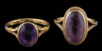 A 9 carat gold amethyst ring,: the oval cut amethyst in a collet setting,