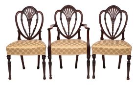 A set of six mahogany and upholstered dining chairs in George III Hepplewhite style,