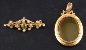 A 15ct gold locket together with a peridot and seed pearl brooch,