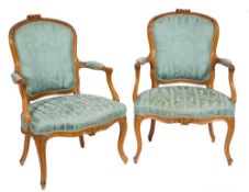 A pair of French carved beech wood fauteuils in the Louis XV taste:,