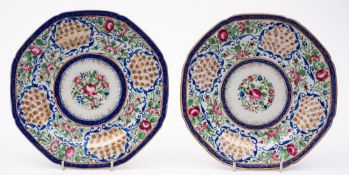 A pair of Chinese porcelain plates for the Arabic market: brightly decorated in famille rose