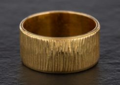 An 18ct gold ring:, with textured surface, hallmarks for London, 1969, ring size Q, total weight ca.