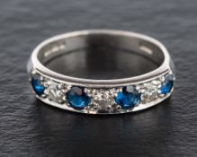 An 18ct white gold, sapphire and round, brilliant-cut diamond, half-eternity ring,