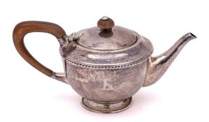A George V hammered silver bachelor's teapot, maker Albert Edward Jones, Birmingham, 1921: crested,