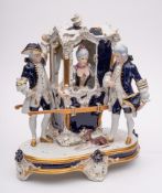A Royal Dux Bohemia porcelain group: modelled as two porters flanking a sedan chair containing an