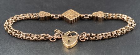 A fancy-link gold bracelet with three foliate engraved panels,