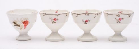 A set of three Daniel egg cups and one similar: painted with floral sprigs and vines,