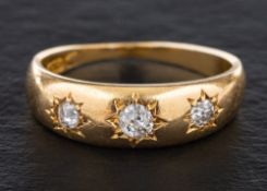An 18ct gold, old-cut diamond, three-stone ring,: total estimated diamond weight ca. 0.