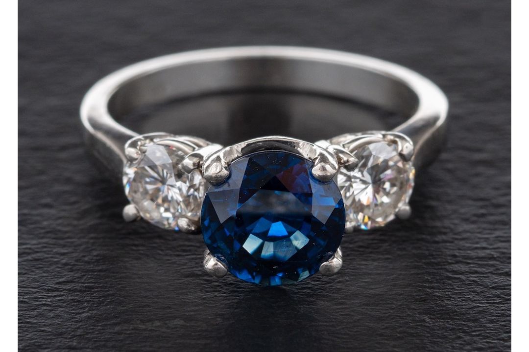 A sapphire and diamond three-stone ring,: calculated sapphire weight ca. 2.