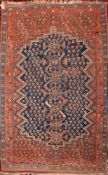 A South Persian Farsistan rug:, the indigo serrated boteh field with geometric designs,