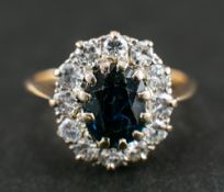A sapphire and round, brilliant-cut diamond cluster ring,: calculated sapphire weight ca.
