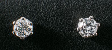 A pair of round, brilliant-cut diamond ear studs,: estimated total diamond weight ca. 0.