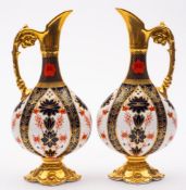 A pair of Royal Crown Derby ewers: in the 'Old Imari' pattern with solid gold borders,