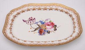 An English porcelain meat dish: of canted rectangular form and gadrooned border,