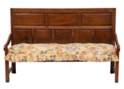 A George II oak settle, mid 18th century and later elements,: with rectangular panelled backrest,