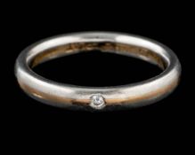 An 18 carat gold and platinum diamond ring,: the brilliant cut diamond set into the polished band,
