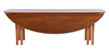 A mahogany wake table in George III style,: the oval top with twin drop leaves and moulded edges,
