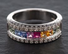 An 18ct white gold ring set with vari-coloured, mixed-cut coloured sapphires,: some synthetic,