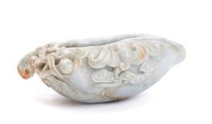 A polished pale blue bowenite bowl: decorated with bats amongst fruit and foliage, 15cm wide.