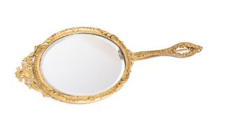 A gilt-bronze framed hand mirror: of oval outline the bevelled mirror plate surmounted by an arched