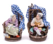 A pair of Continental porcelain figure groups: modelled as a cobbler and a seamstress within a