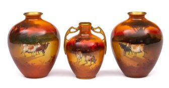A pair of Royal Doulton vases and one smaller: the former of oviform painted with cattle in a