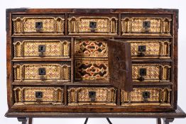 A Spanish polychrome painted and parcel gilt vargueno on stand, in 16th century style,