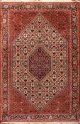A Tabriz rug:, the ivory hexagonal field with geometric flowerhead, lattice and lozenge designs,