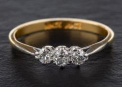 A round, brilliant-cut diamond three-stone ring,: total estimated diamond weight ca. 0.
