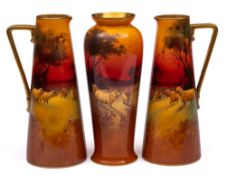 A pair of Royal Doulton ewers and a matching vase: the former of tapering form with angular handles