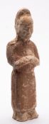 A Chinese funerary figure: modelled in the form of an elegant lady with arms folded across her