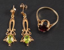 A pair of 9ct gold, oval, mixed-cut peridot earrings and a 9ct gold garnet ring,