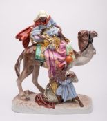 A large Royal Dux Bohemia porcelain group: modelled as an Arab atop a camel with a young lad with