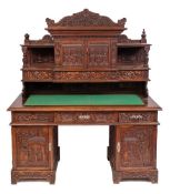 A Chinese carved wood pedestal desk, early 20th century,: with all over decoration of flowers,