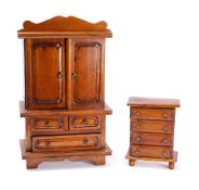 An apprentice's mahogany linen press: the arched cornice above a pair of panelled cupboard doors,