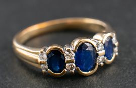 A 9ct gold, sapphire and round, brilliant-cut diamond ring,: total diamond weight ca. 0.