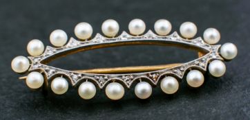 A navette-shaped brooch to cultured pearls and rose-cut diamond surround,