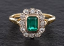 A 18ct gold emerald and round, brilliant-cut diamond cluster ring,: calculated emerald weight ca 0.