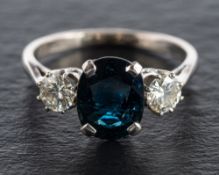 An oval mixed-cut sapphire and round, brilliant-cut diamond, three-stone ring,