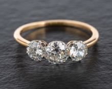 An old-cut diamond, three stone ring,: total estimated diamond weight ca. 1.