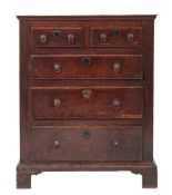 An early George III oak chest of drawers, circa 1765,: the cleated top with moulded edges,