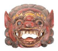 A Burmese carved wood and polychrome decorated dragon mask: of traditional design with open mouth