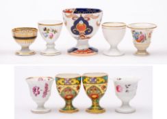 A group of nine egg cups: including a Chamberlains Worcester gilt and black decorated cup,